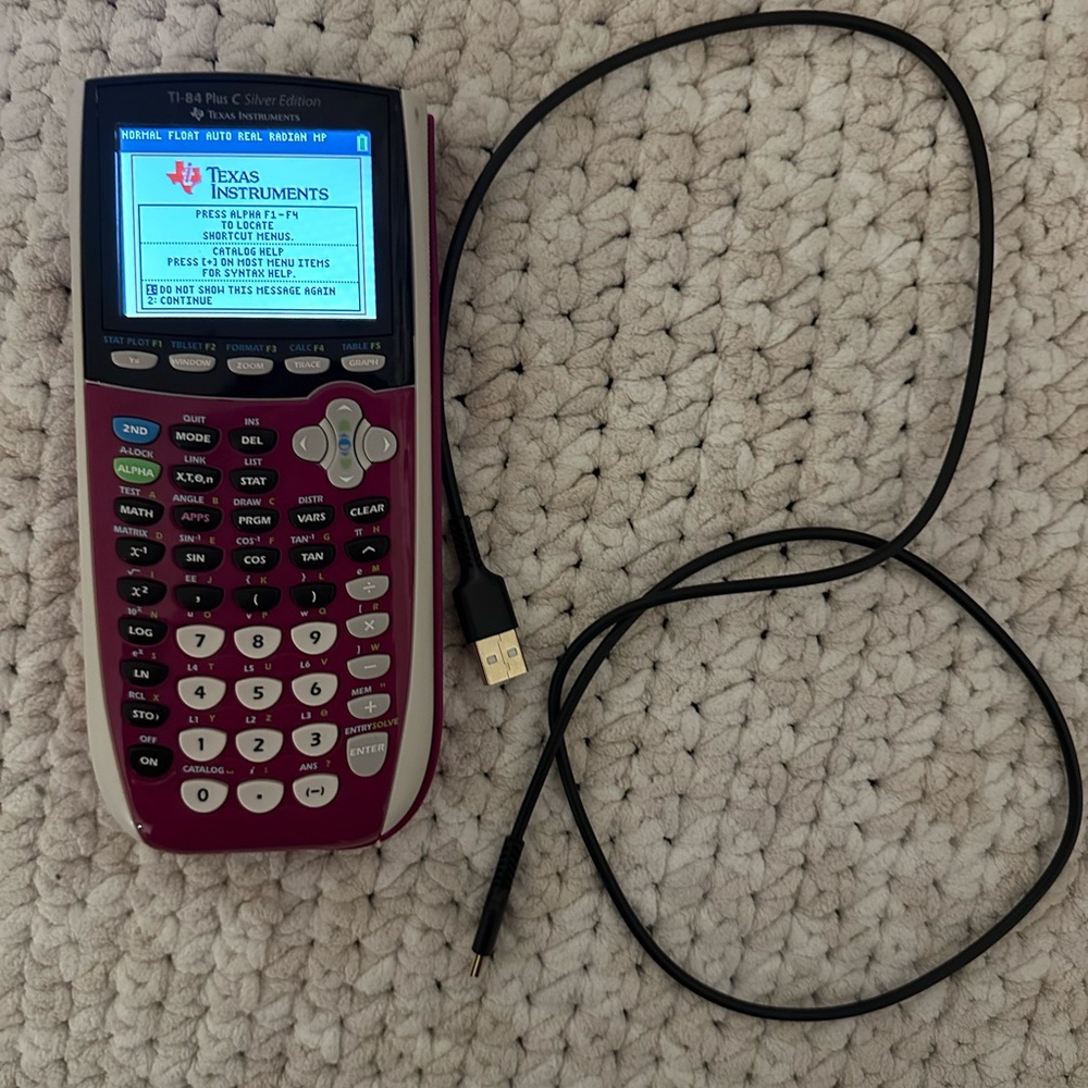 Texas Instruments 84 Pink graphing calculator with charging cable